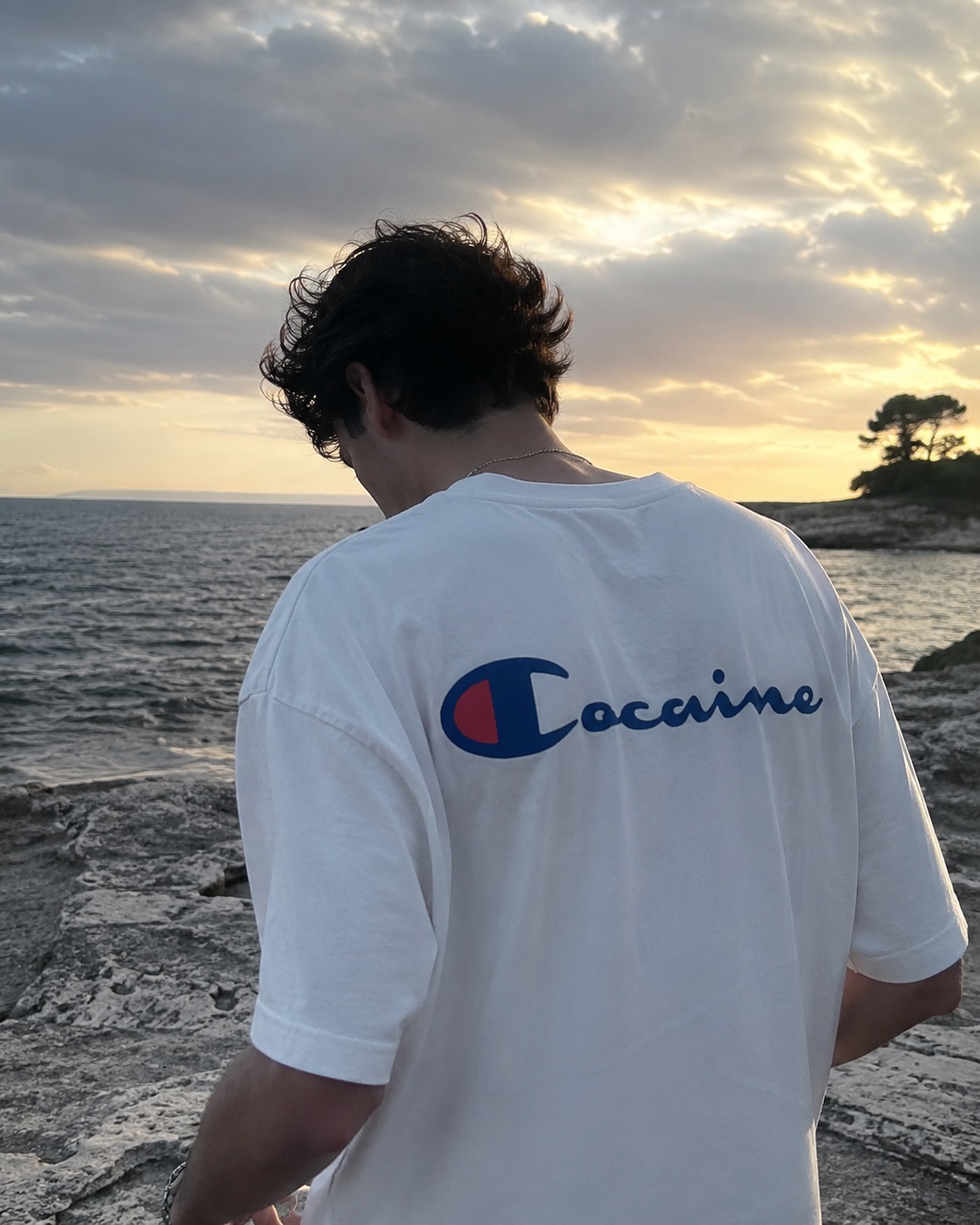 Cocaine script tee in white, worn at the beach