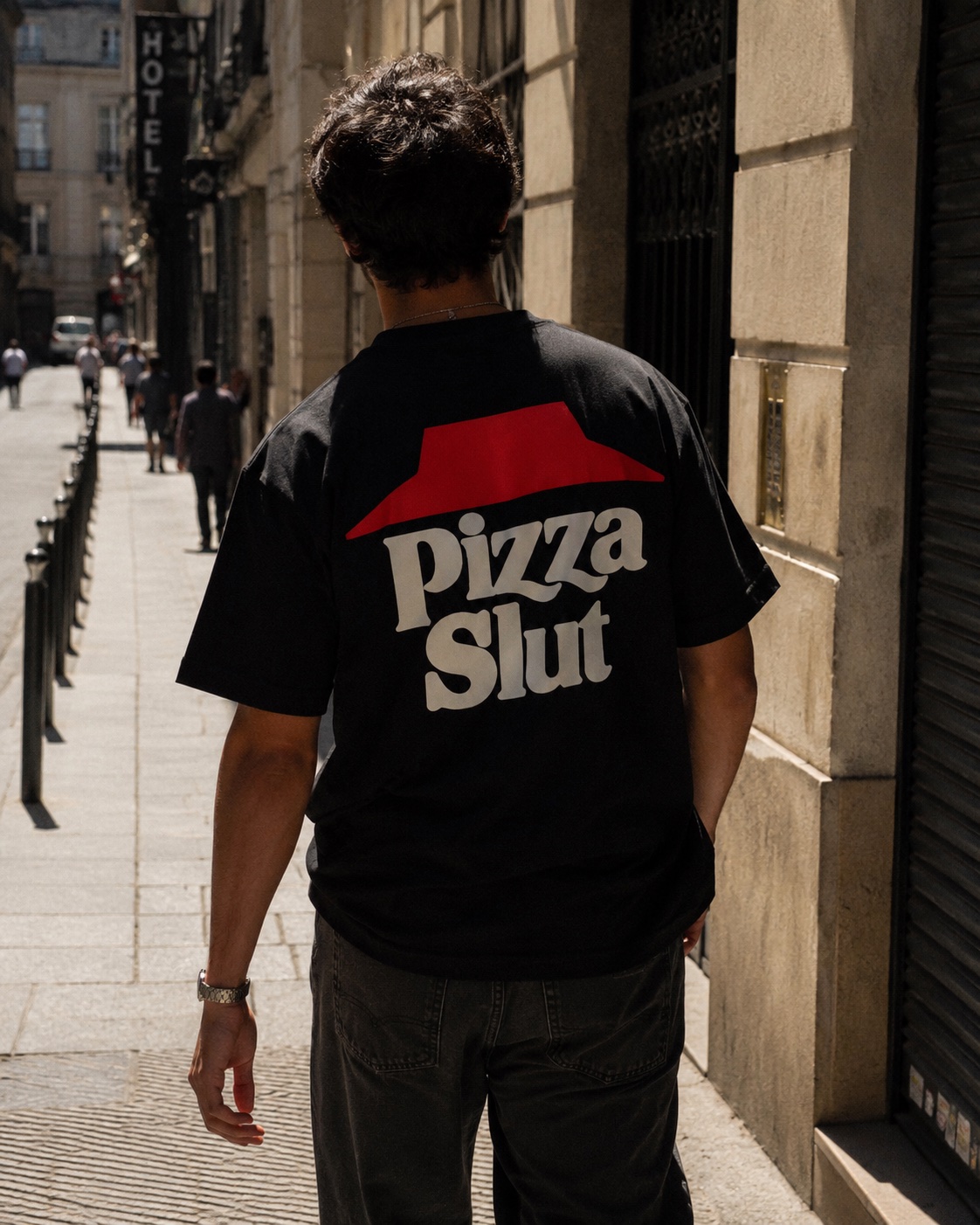 Pizza Slut tee in black, worn on the street