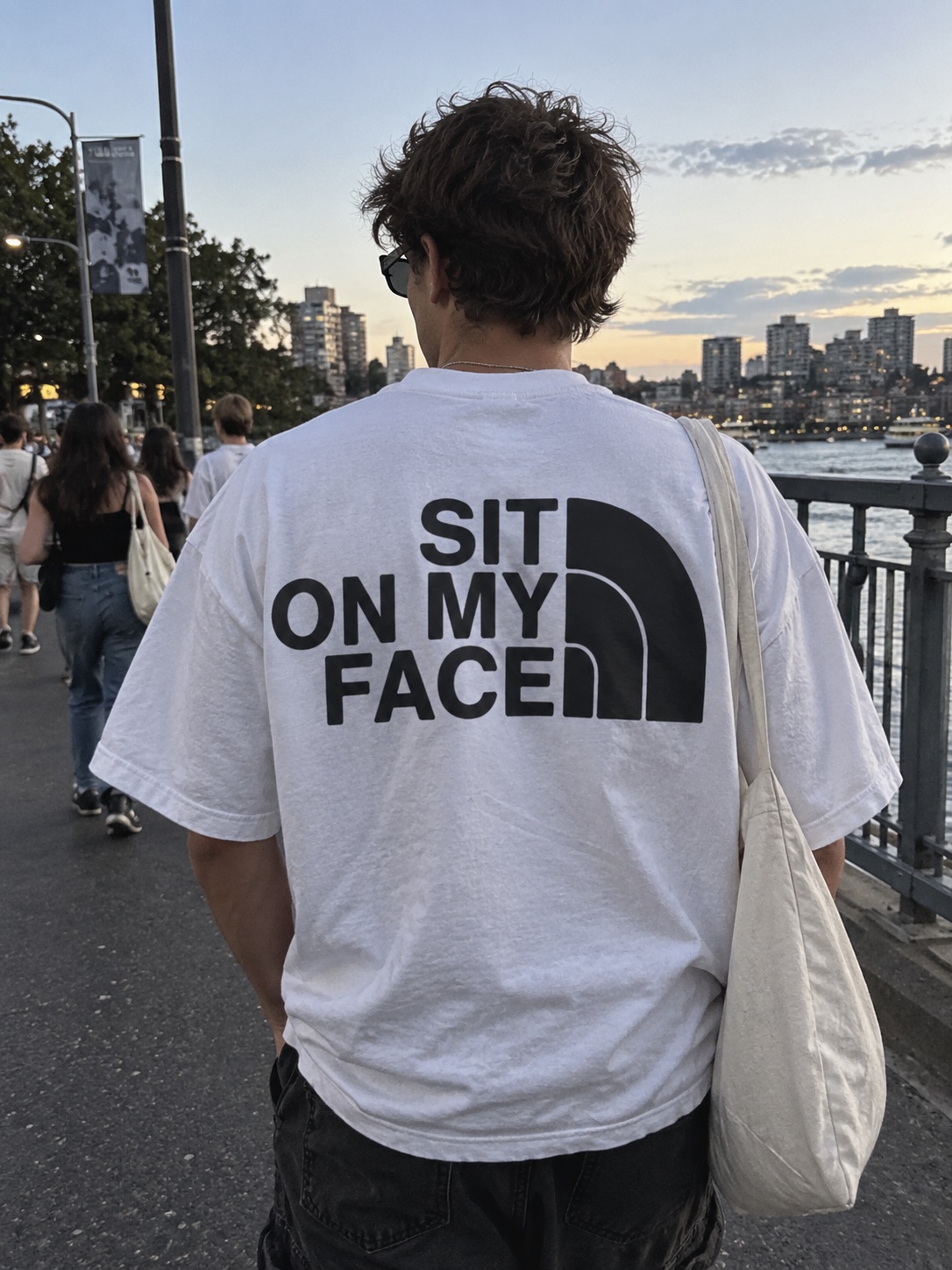 Sit on My Face tee in white, worn on the street